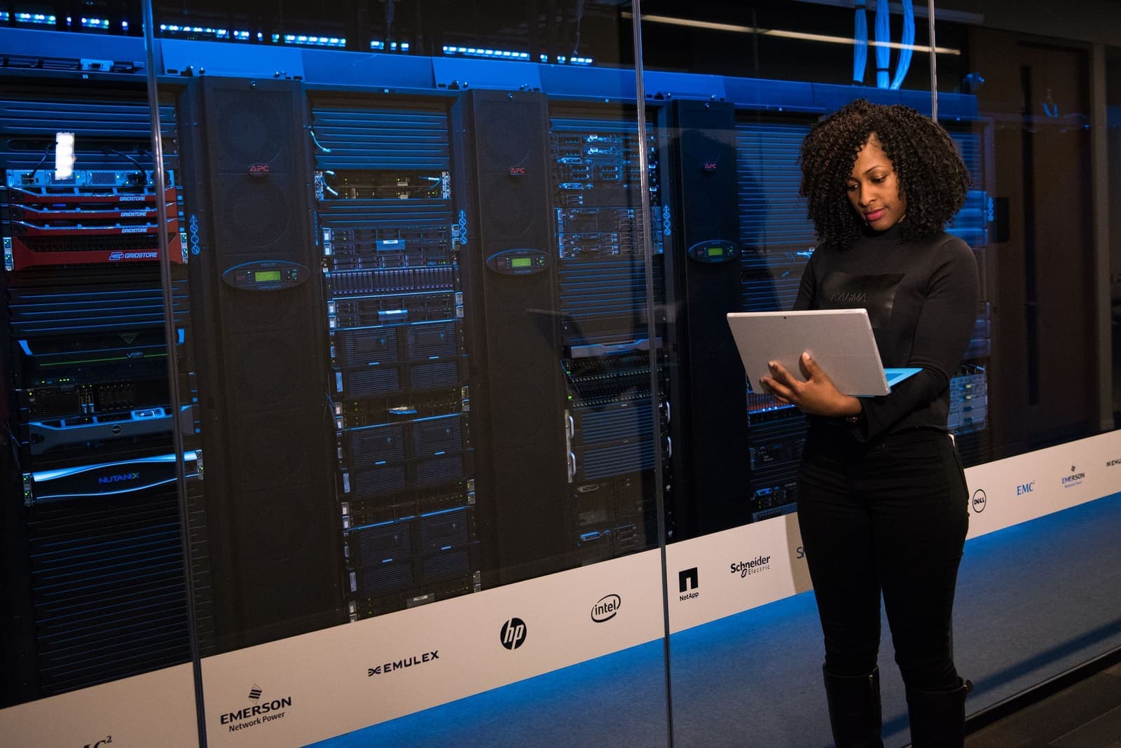 Infrastructure engineer inspecting a datacenter with a laptop