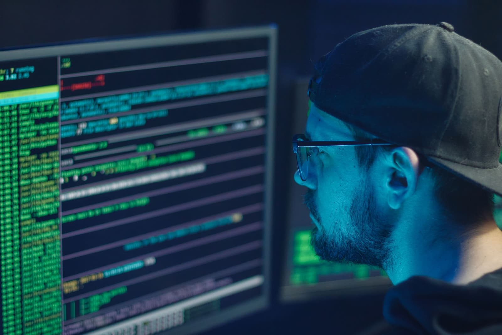 Security analyst reviewing system activity across multiple screens