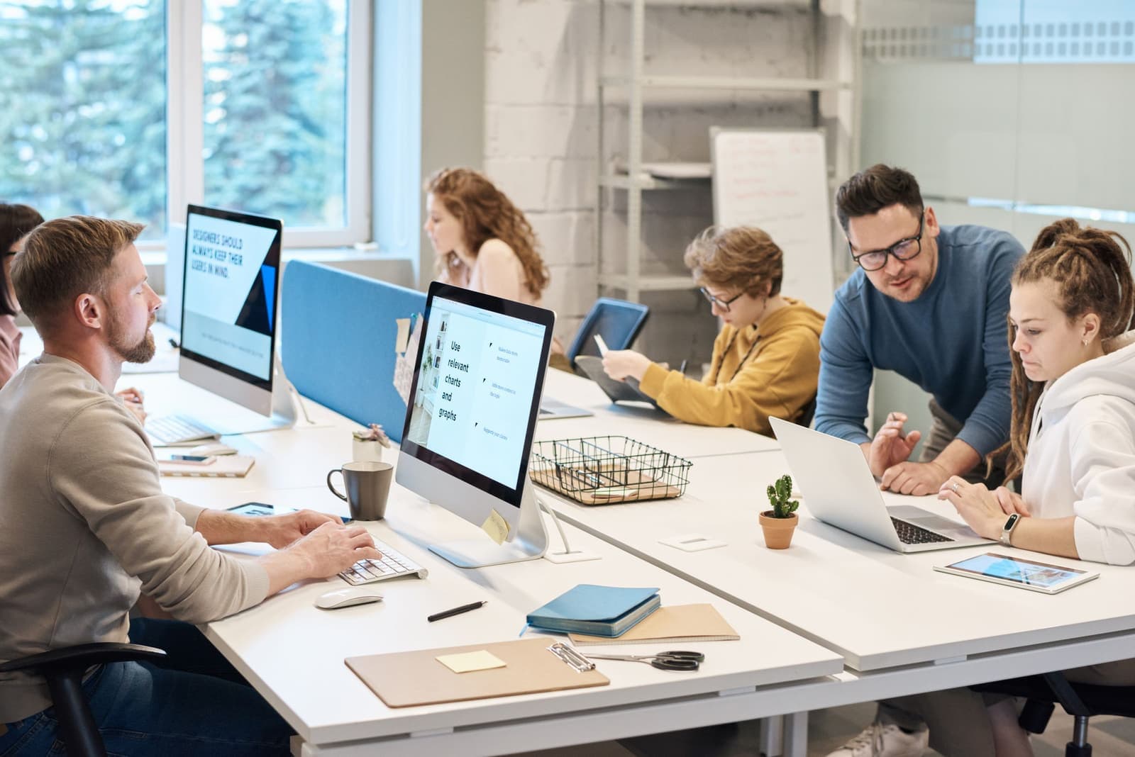 Operations team coordinating work across a shared office table