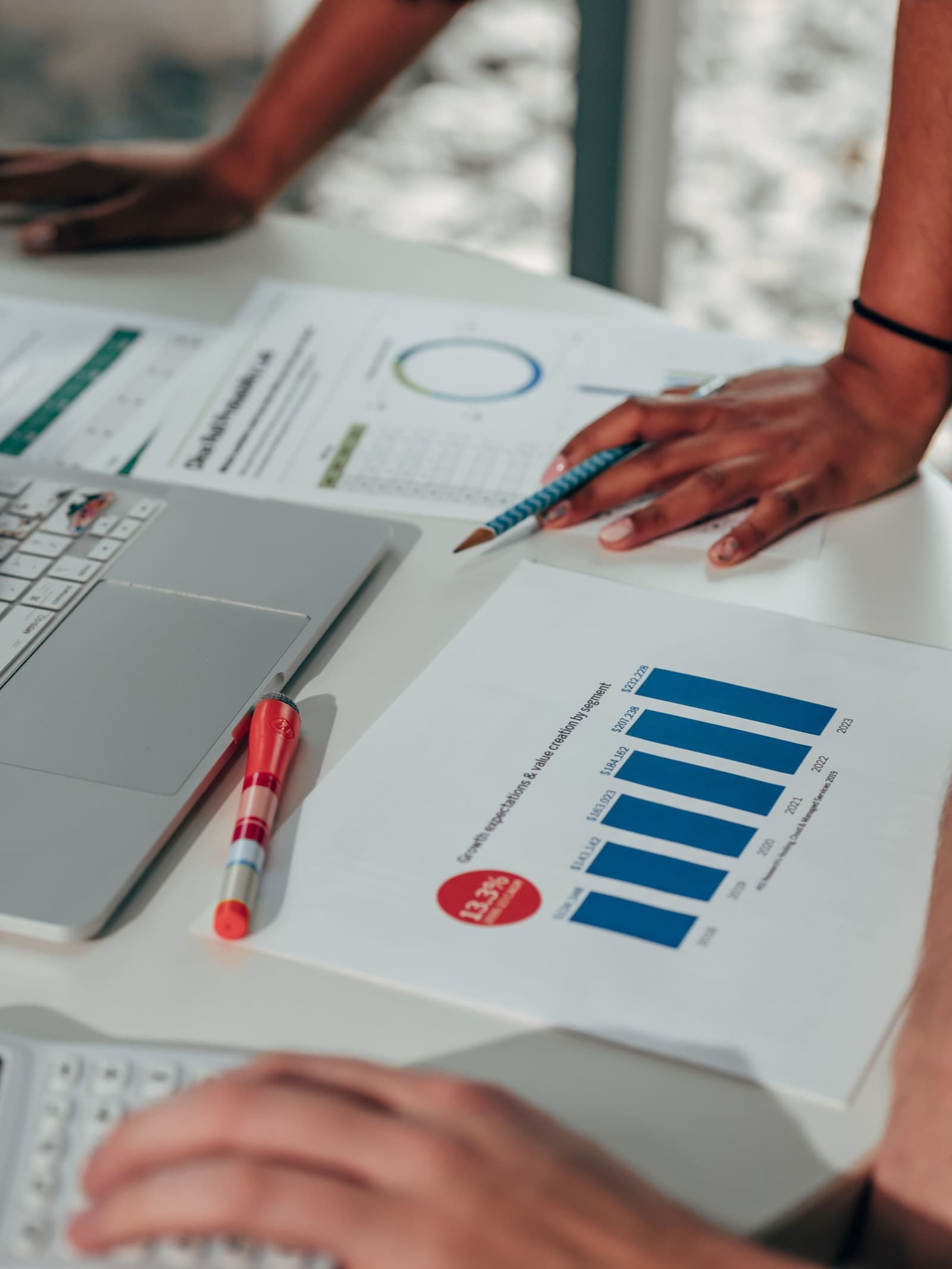 Business team mapping data and workflow improvements at a desk