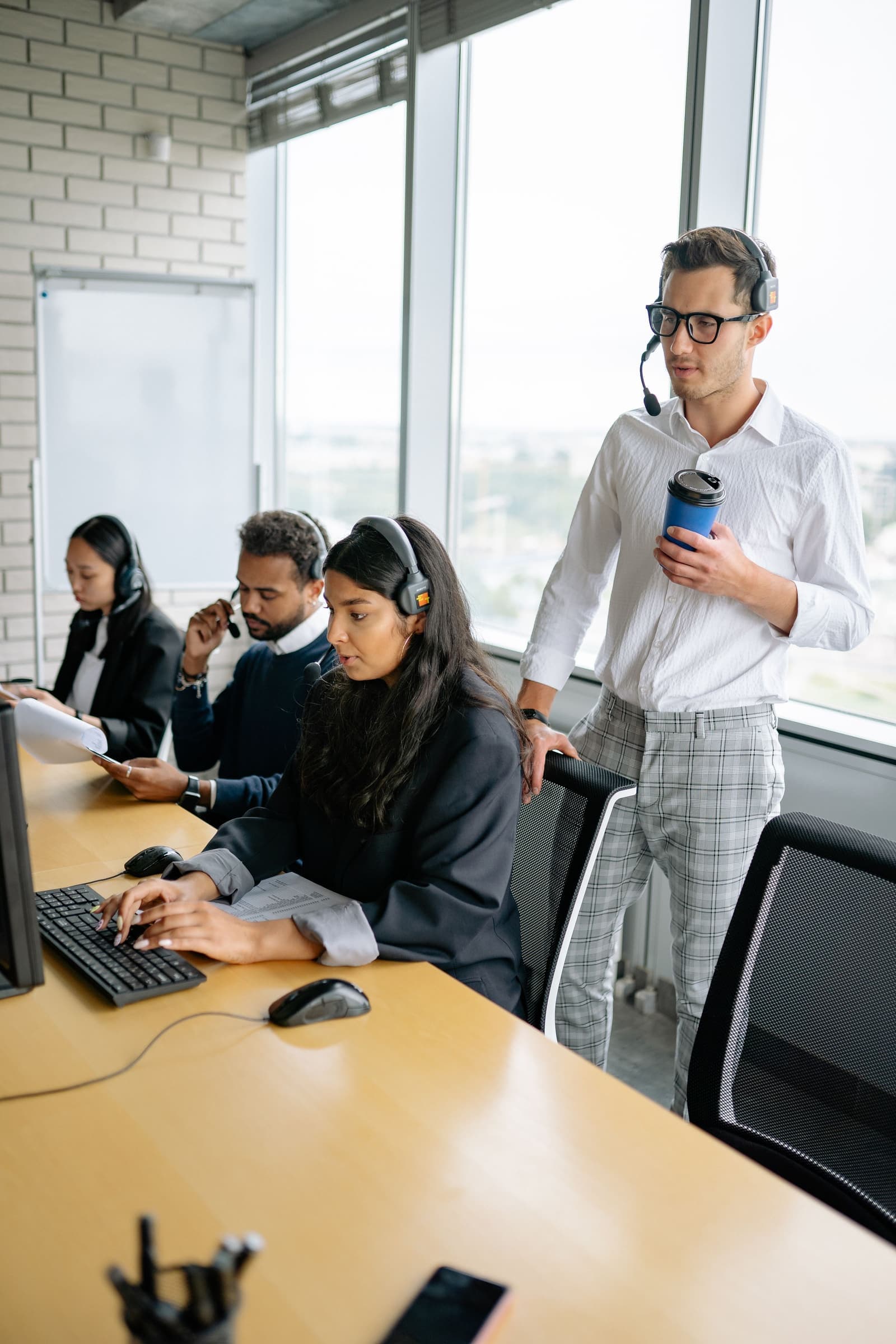 Support specialists assisting customers from a bright operations floor
