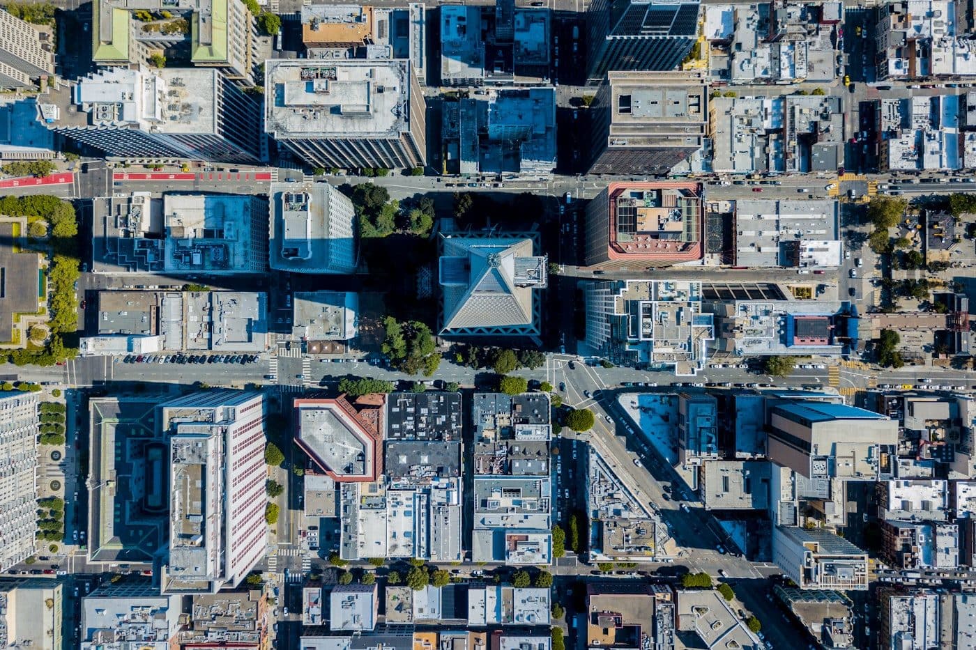 Overhead aerial view of a dense city grid of office blocks