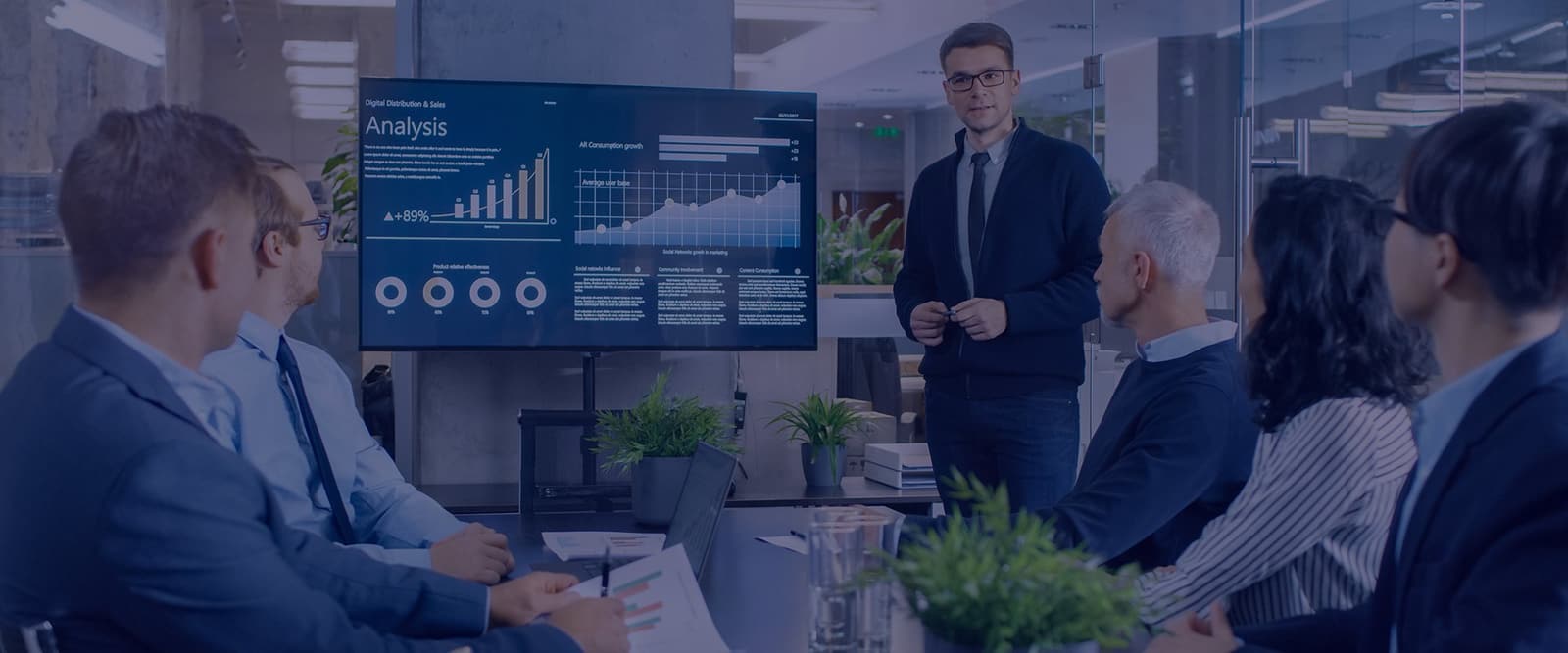 A presenter walking a boardroom through an analytics dashboard