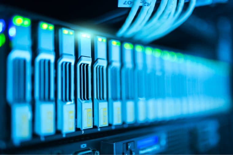 A row of blade servers with status lights and patch cabling in a rack