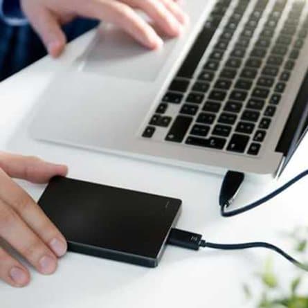 An external backup drive connected to a laptop