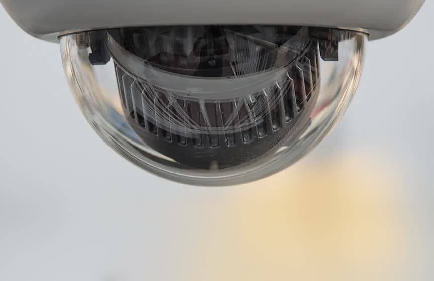 A dome security camera mounted on a ceiling